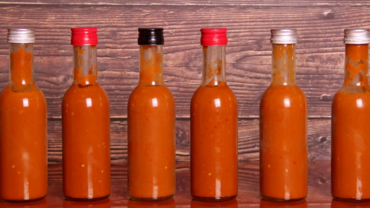 Hot sauce bottles in a row