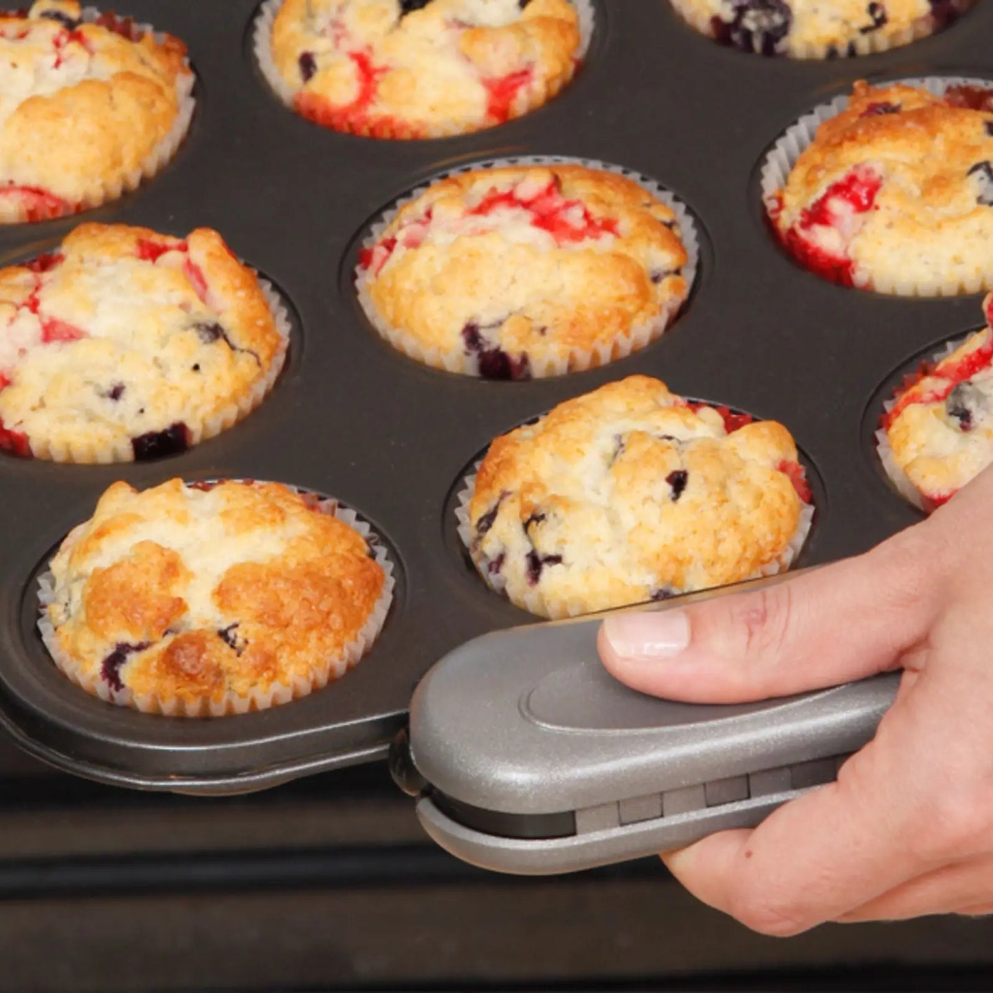 pebblegrip gripping a muffin baking tray edge. Heat resistant  grip baking